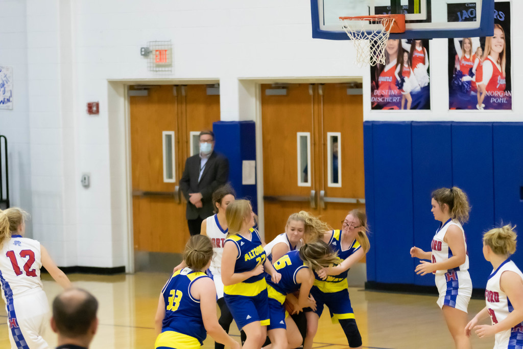 girls fight for basketball under net