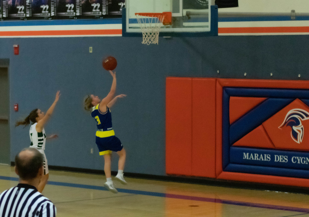 AMHS girls basketball player shoots layup